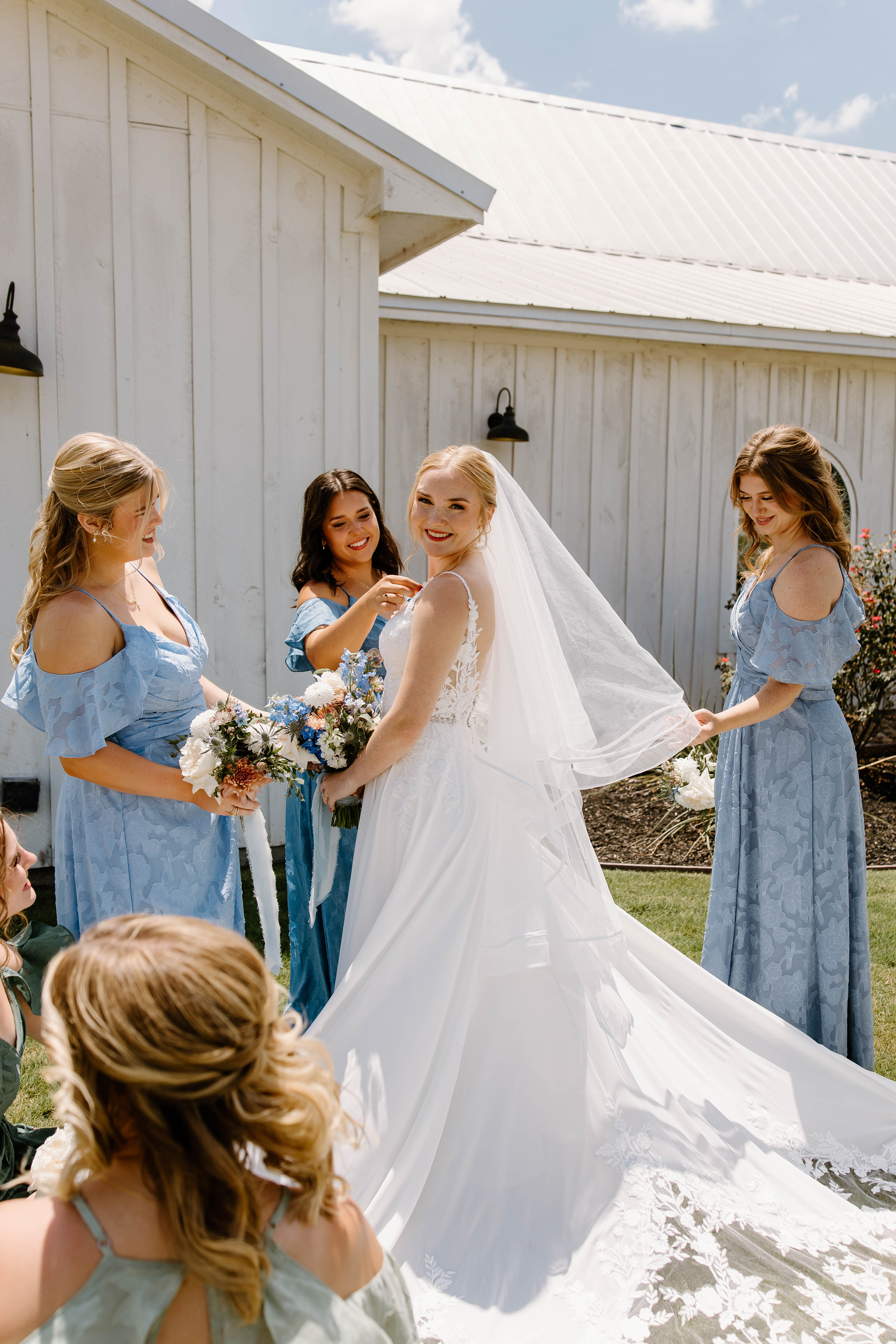 Brooke with her bridesmaids and their bouquets outside the chapel