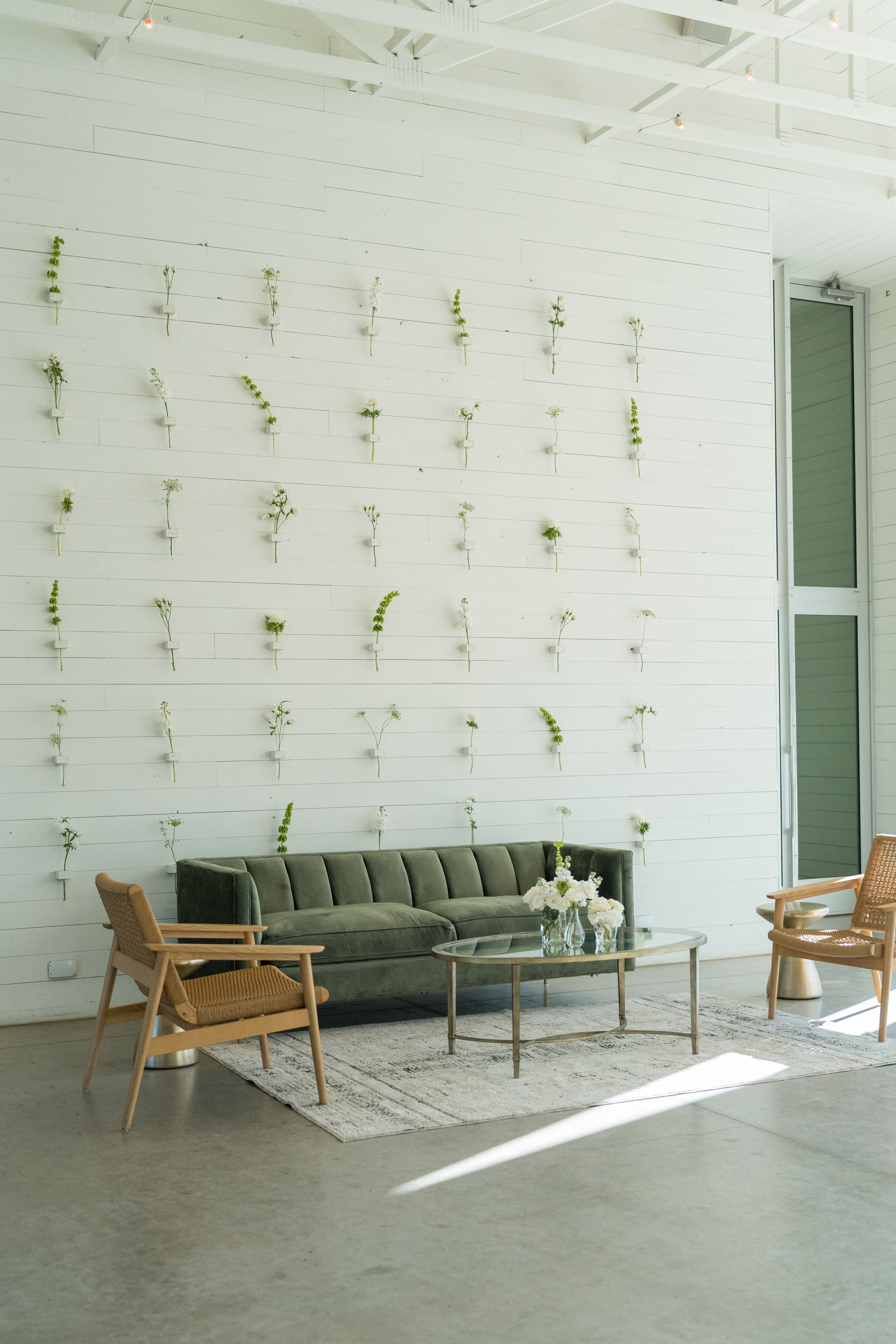 Couch lounge with wall vial floral installation