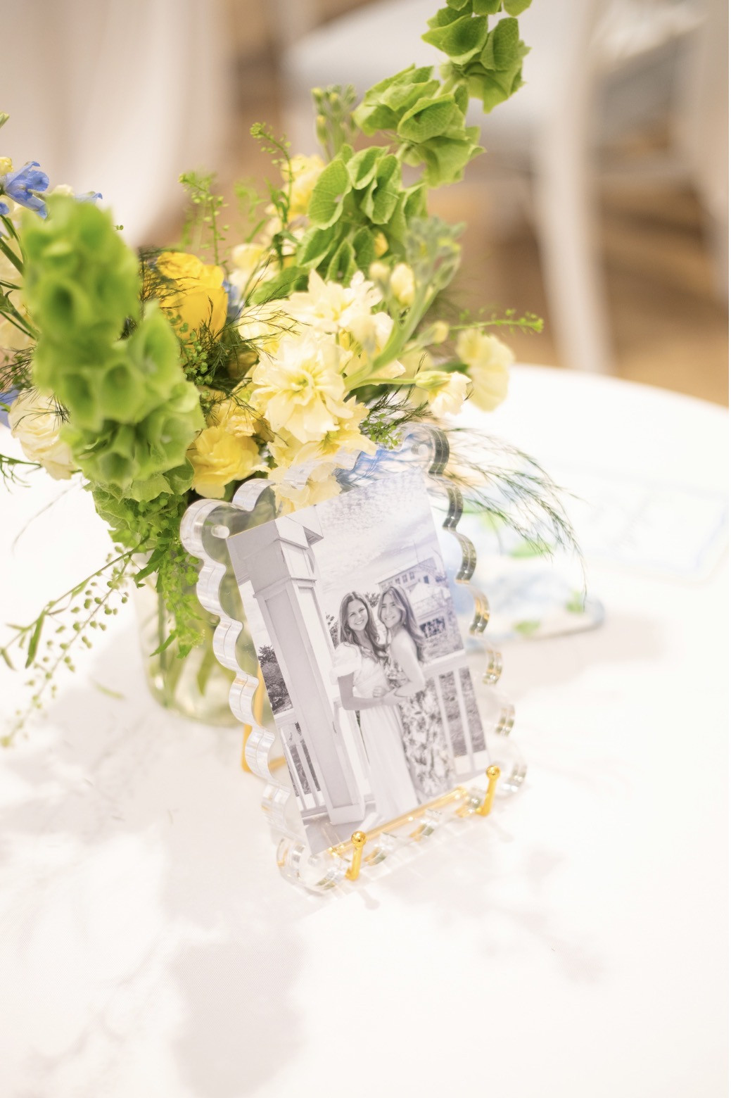 Pastel floral centerpiece beside a framed photograph at the Tri Delt gathering