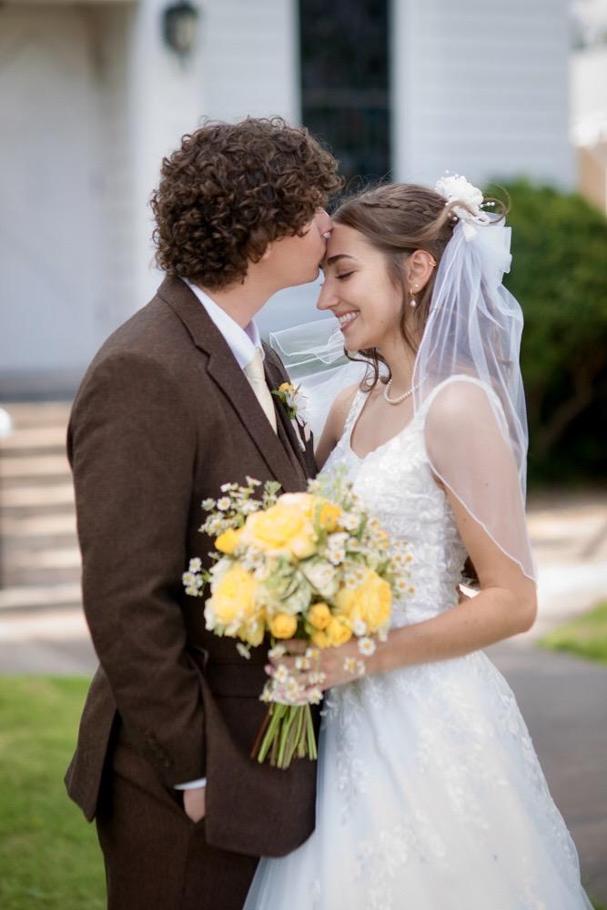 Cade kissing Whitney on their wedding day