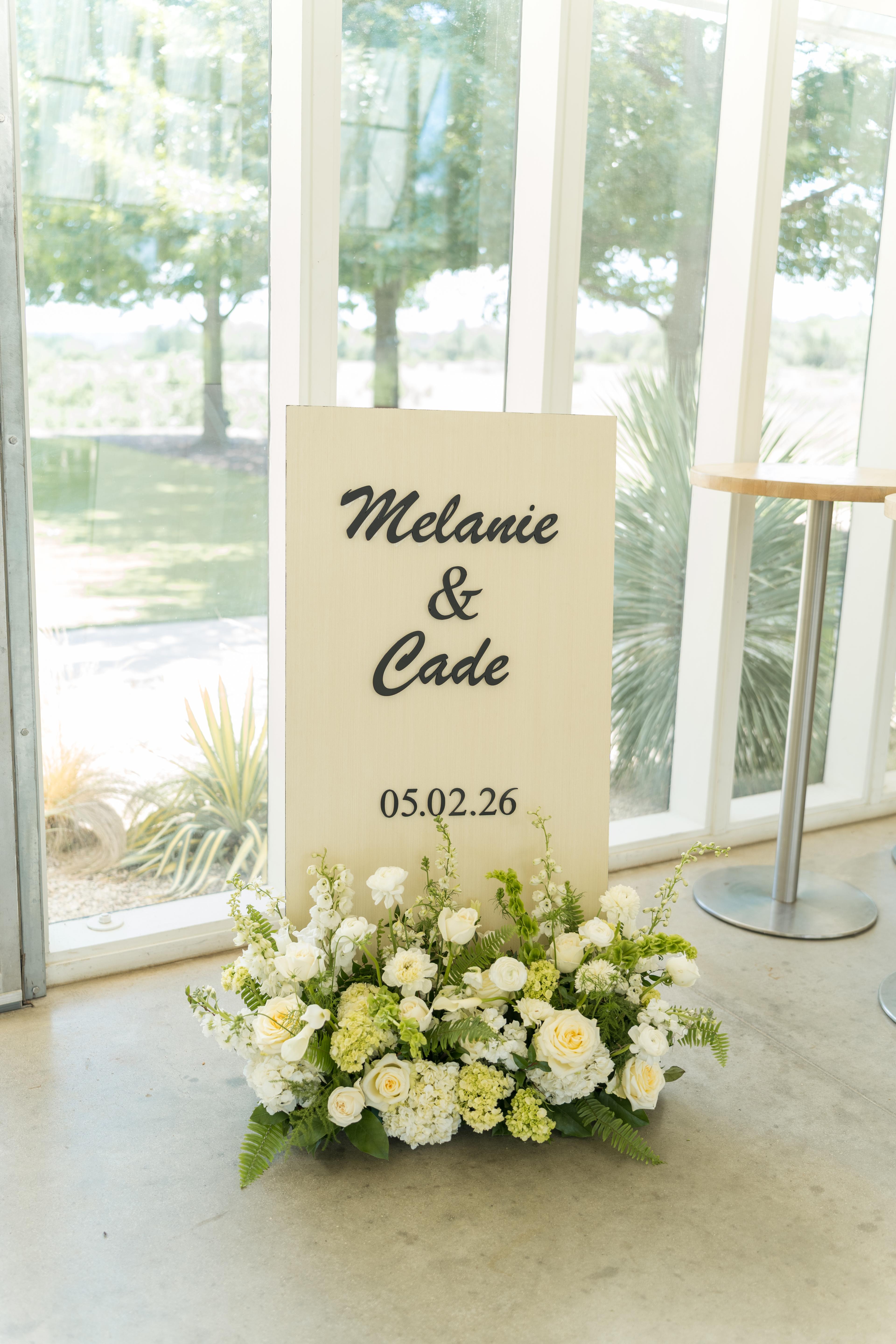 Melanie and Cade wedding sign with floral detail
