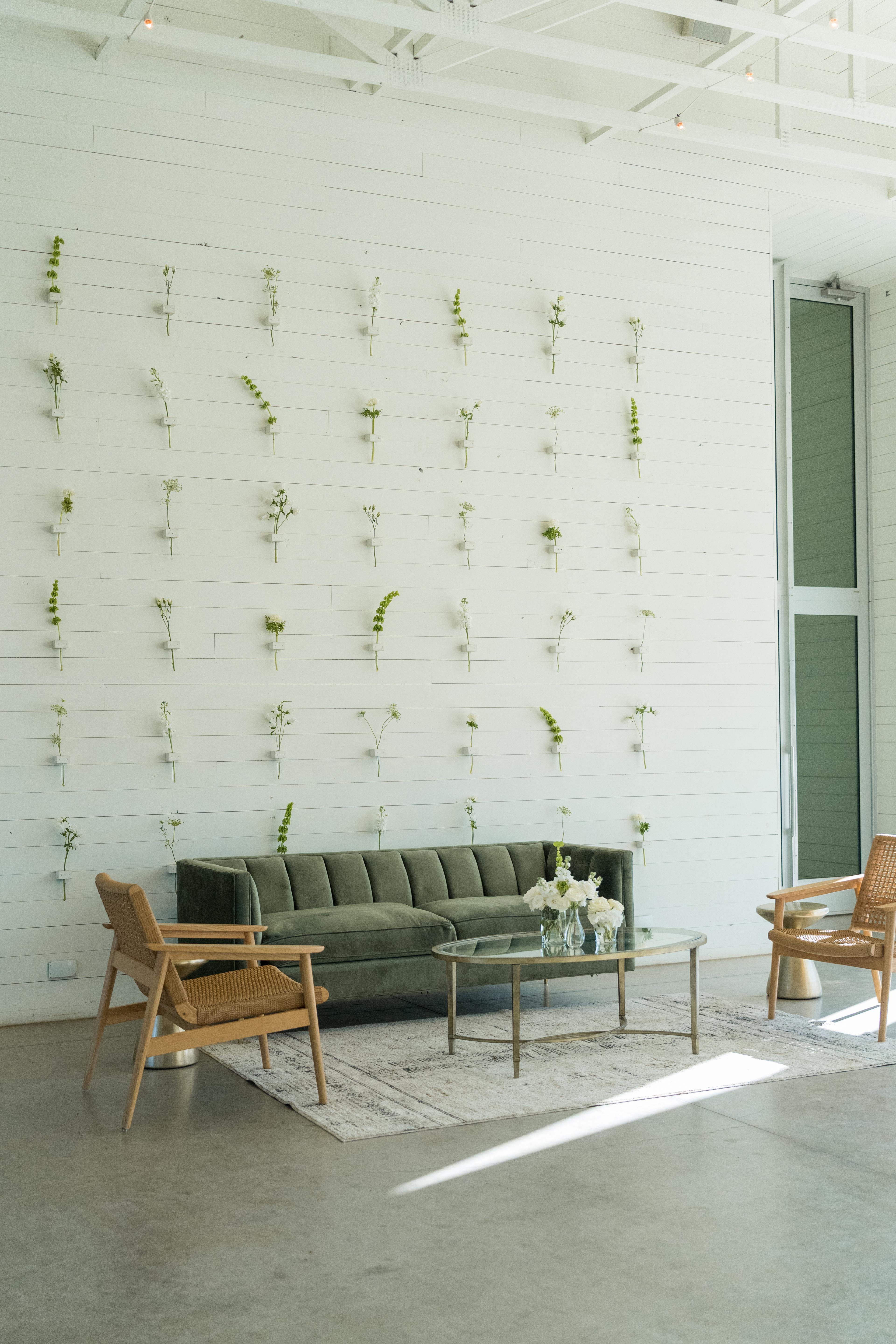 Couch lounge with wall vial floral installation