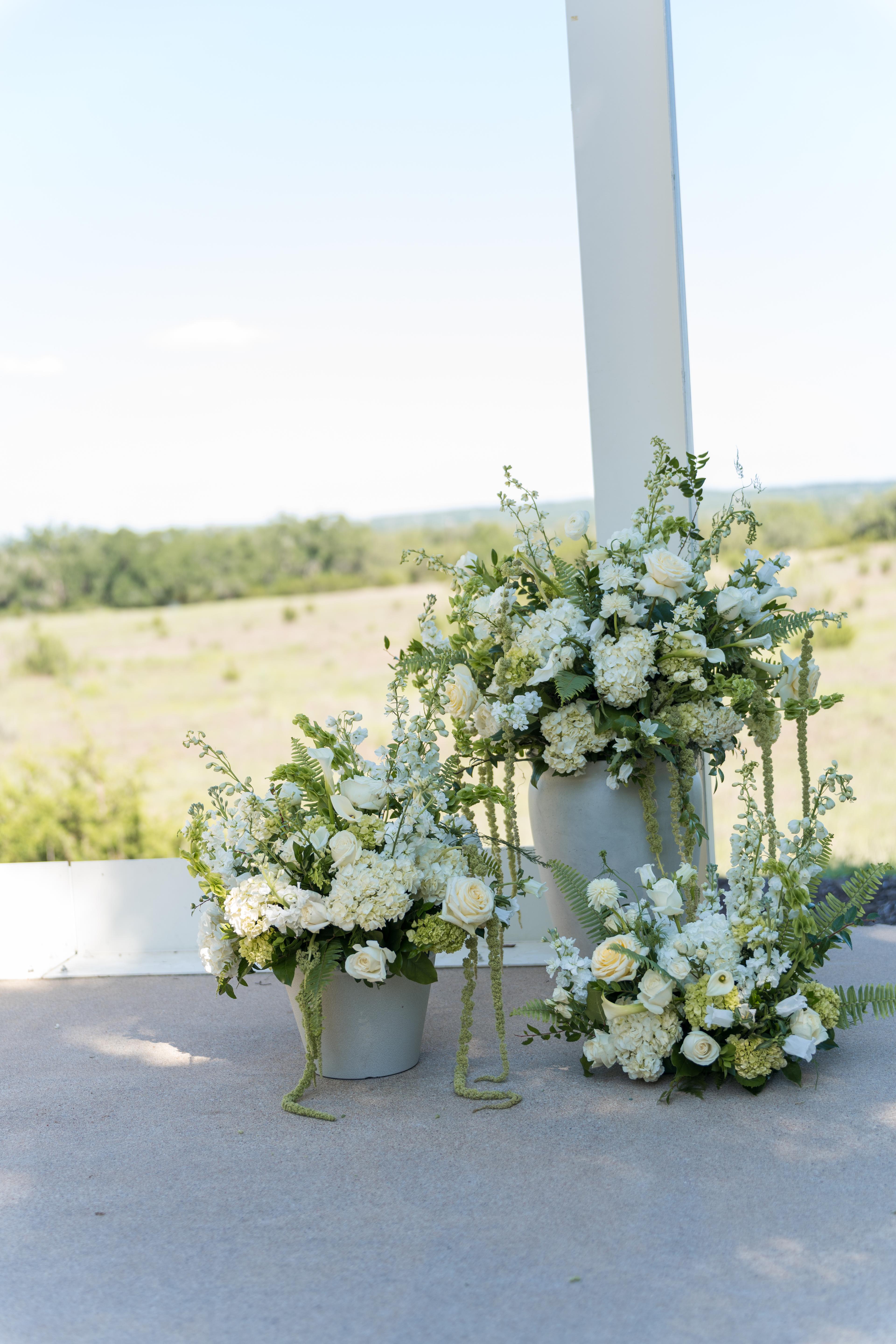 Three altar floral pieces for Melanie and Cade's wedding
